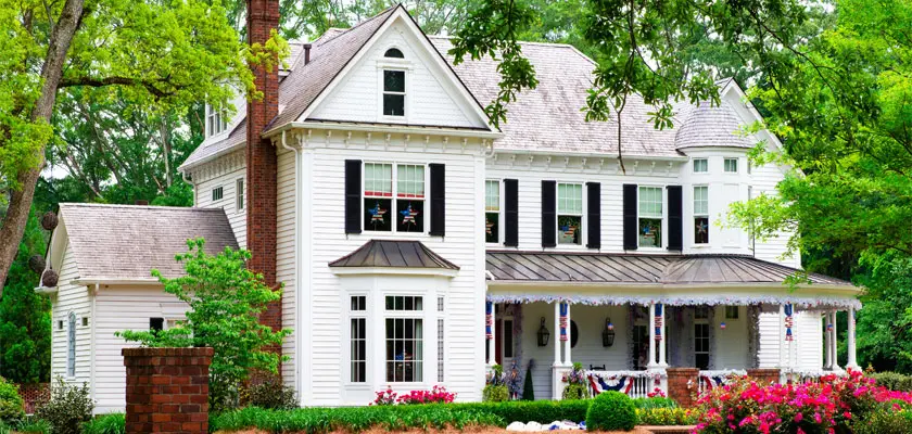 White Home With American Flag Decorations