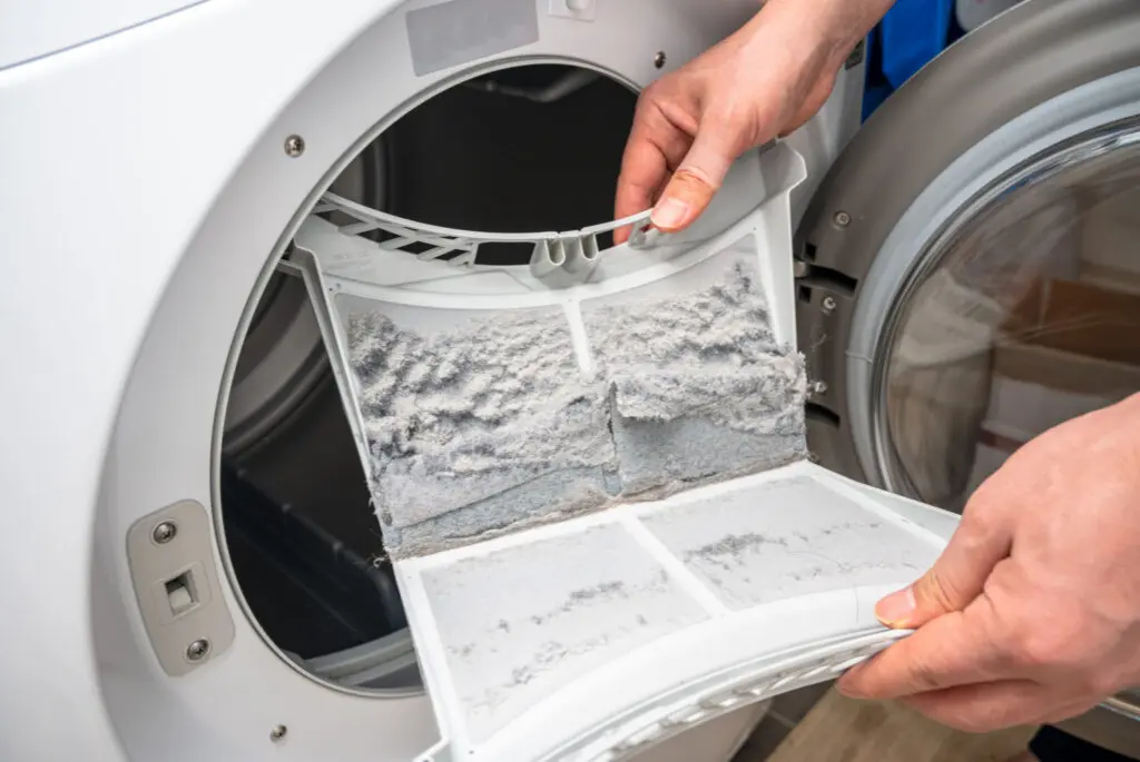 Cleaning clothes dryer lint filter. 