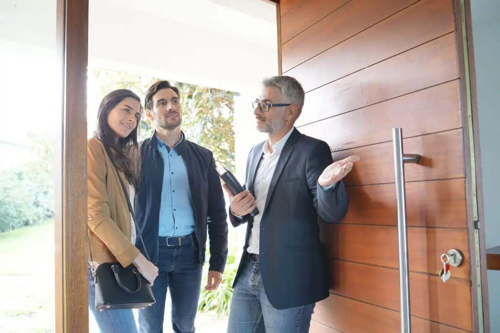 Couple with real estate agent looking at house 