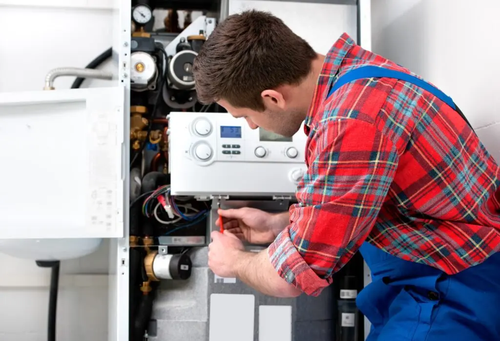 Repair service technician working on a malfunctioning water heater.